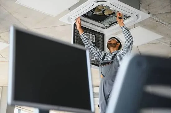 Ceiling cassette air conditioner opened for indoor HVAC service