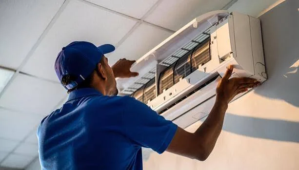 Wall-mounted air conditioner with the front cover open during indoor cooling service