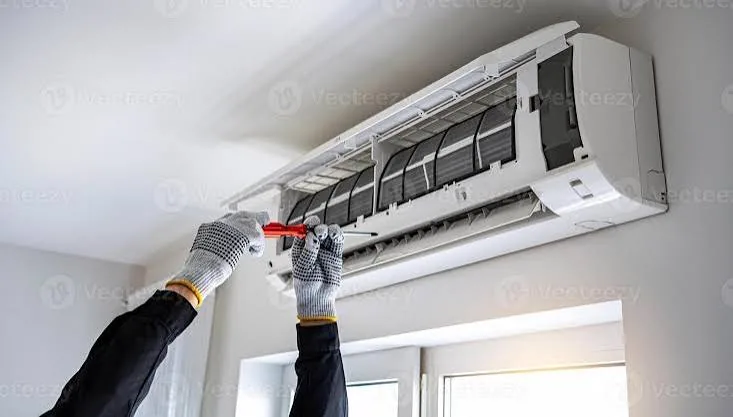 Indoor wall air conditioner opened for troubleshooting with a screwdriver